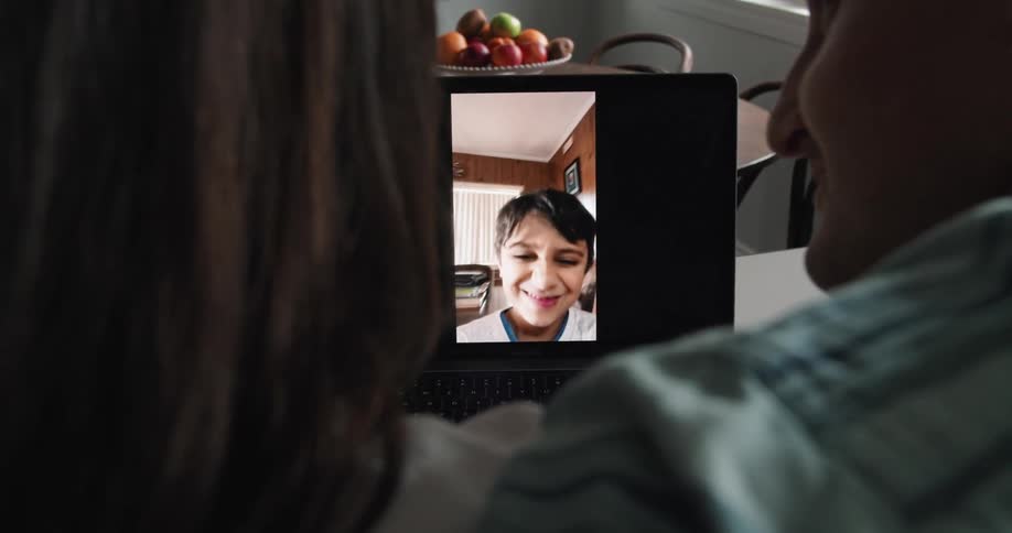 An older couple talking to a person through a video call