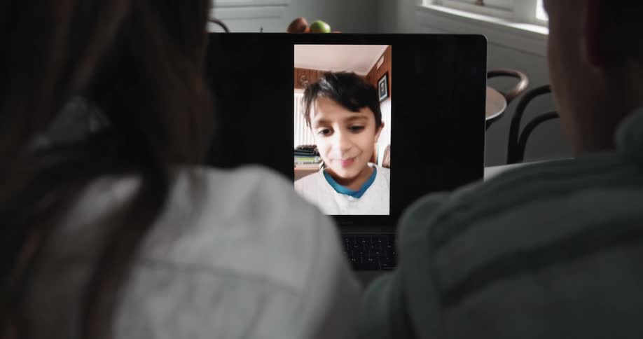 Family having a video call on a laptop from home