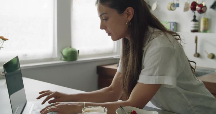 A woman typing on a laptop