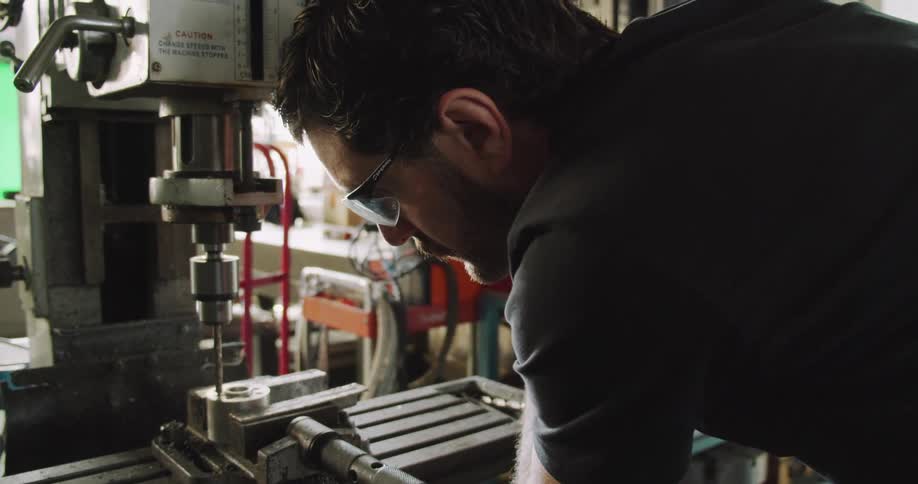 A man working with a large tool
