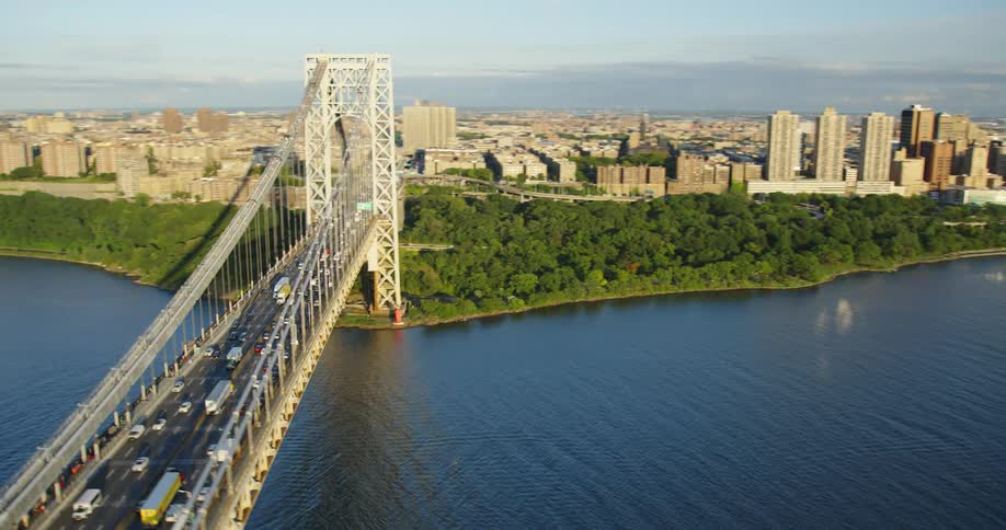 Aerial shot of a bridge going into a city