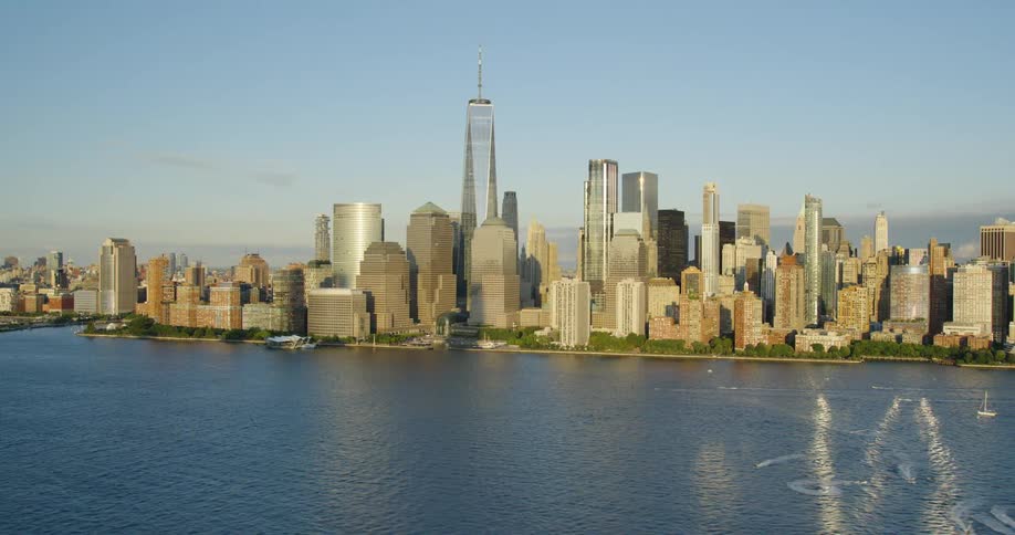 An aerial view of a city skyline with high rise office buildings on the coast