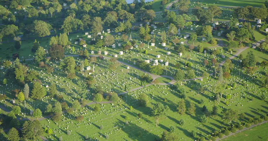A large cemetery in the countryside on a sunny day