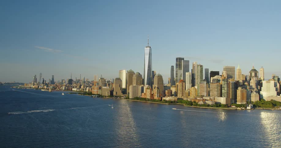 An aerial view of city skyline off the water with boats
