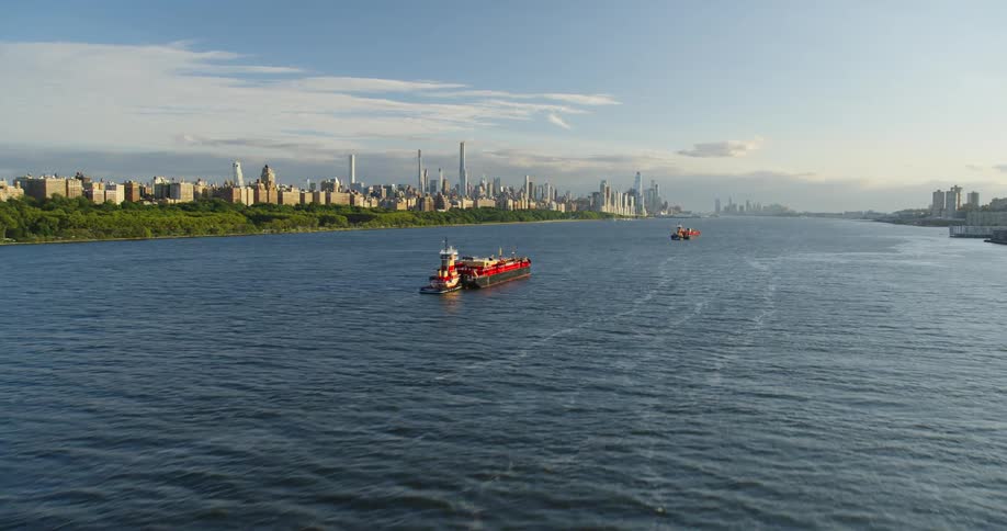 Boats and ships sail in the river by the city