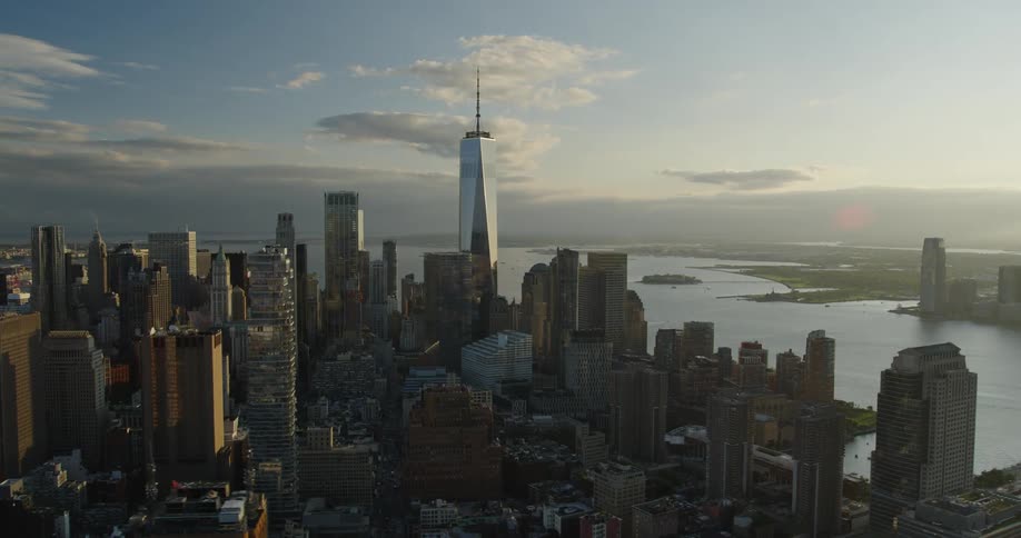 Sun shines over an aerial view of a tower block in a metropolis in the afternoon