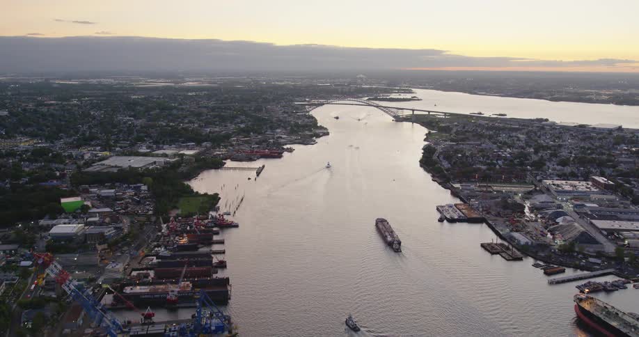 Aerial view of the bridge connecting a small town over a river at sunset