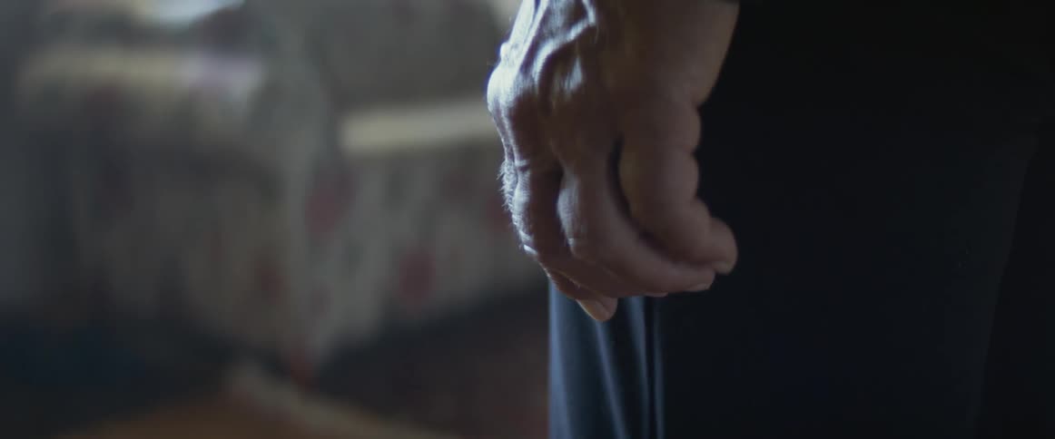 Close up of an elderly womans hand with wrinkles in the dining room