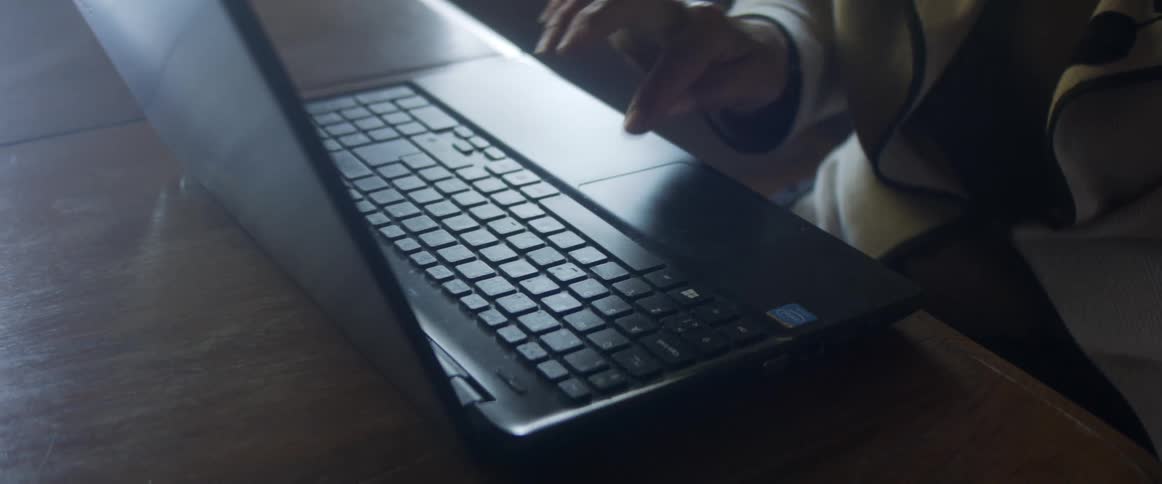 A person is typing on a laptop