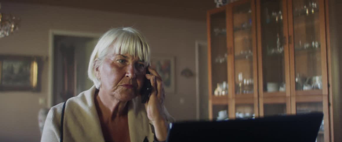 A woman is talking on the phone indoors