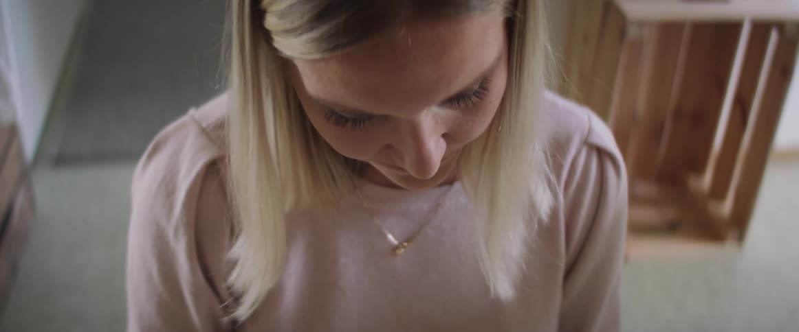 Blonde woman standing in a room at home