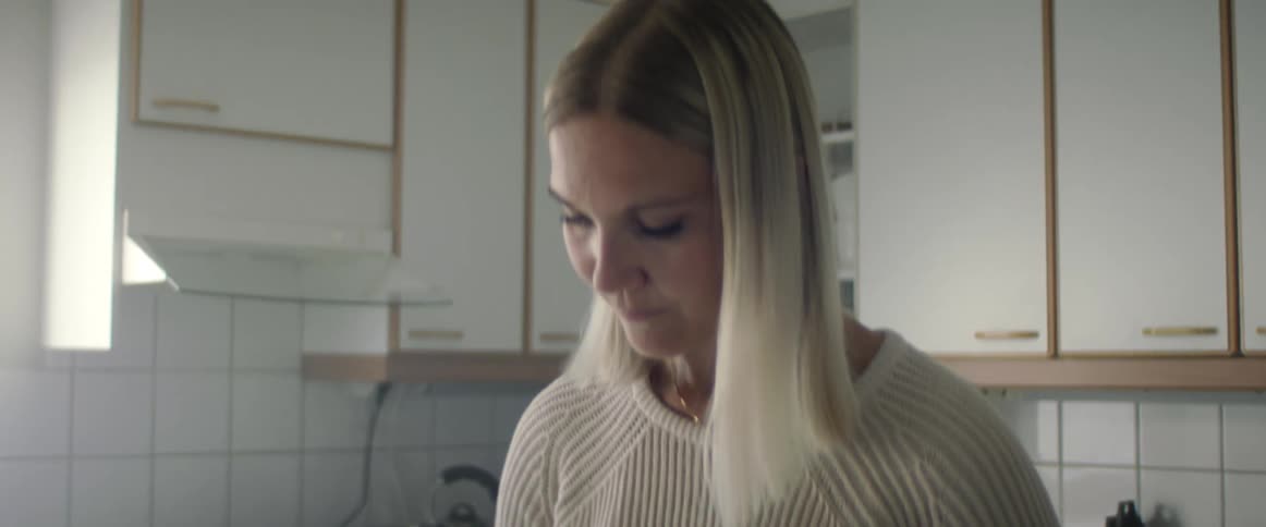 A woman cutting fruit in her kitchen