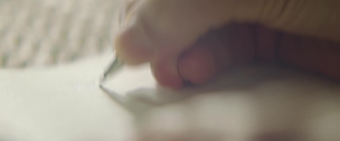 Close up of a hand writing in a notebook