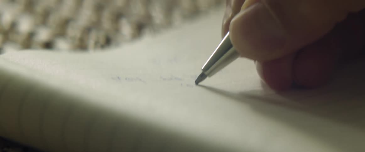 A person writing in a notebook