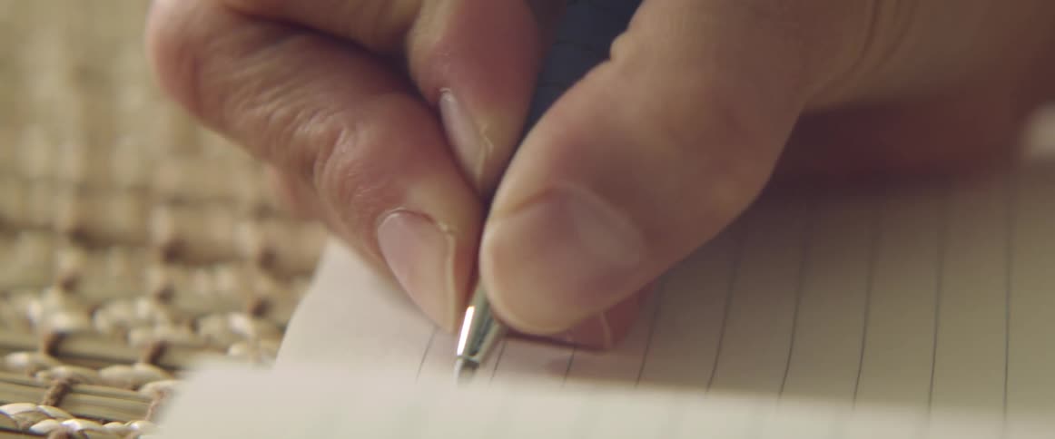 A woman writing in a notebook