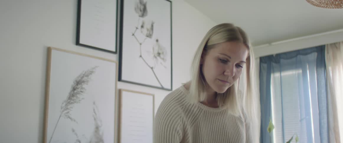 Blonde woman writes down something on a room at home