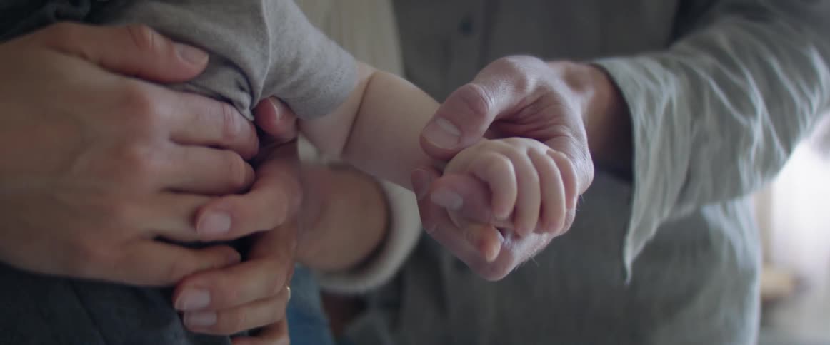 A baby being hugged and held by a person