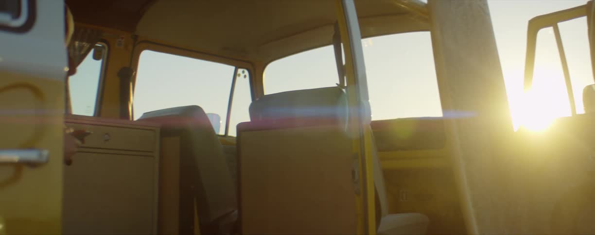 Van with open doors on the beach