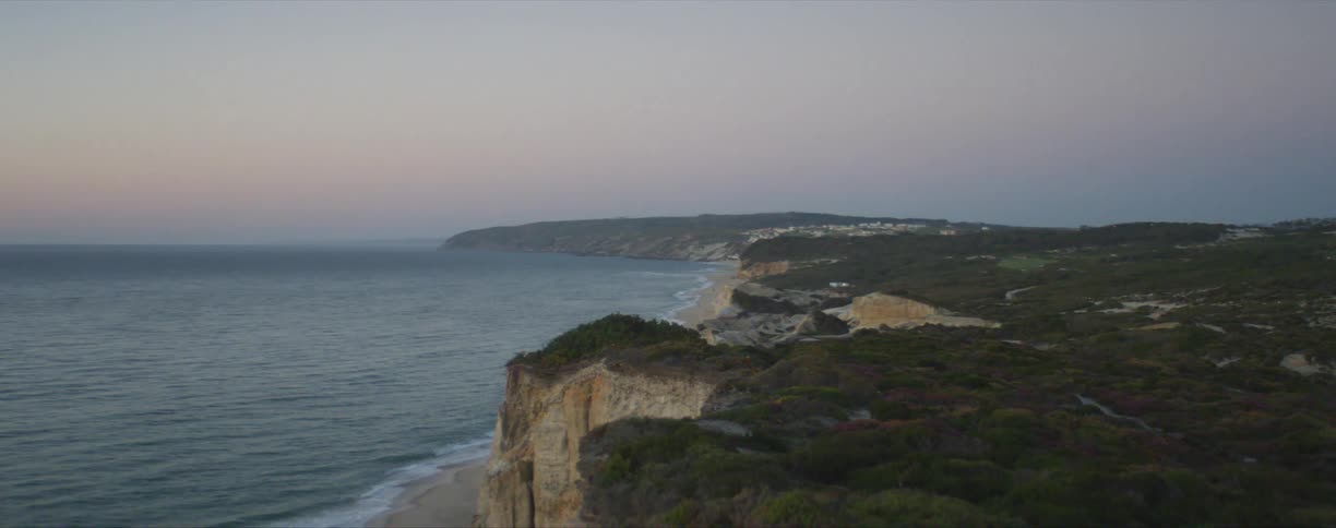 Wide shot of a cliff by a coast