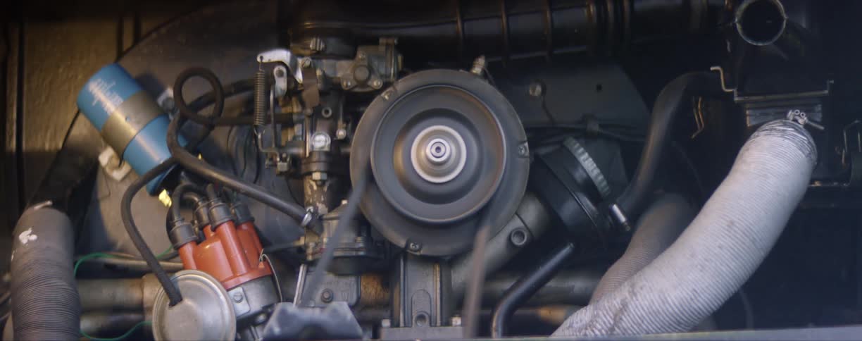 A motor with a belt moving and hoses and other components