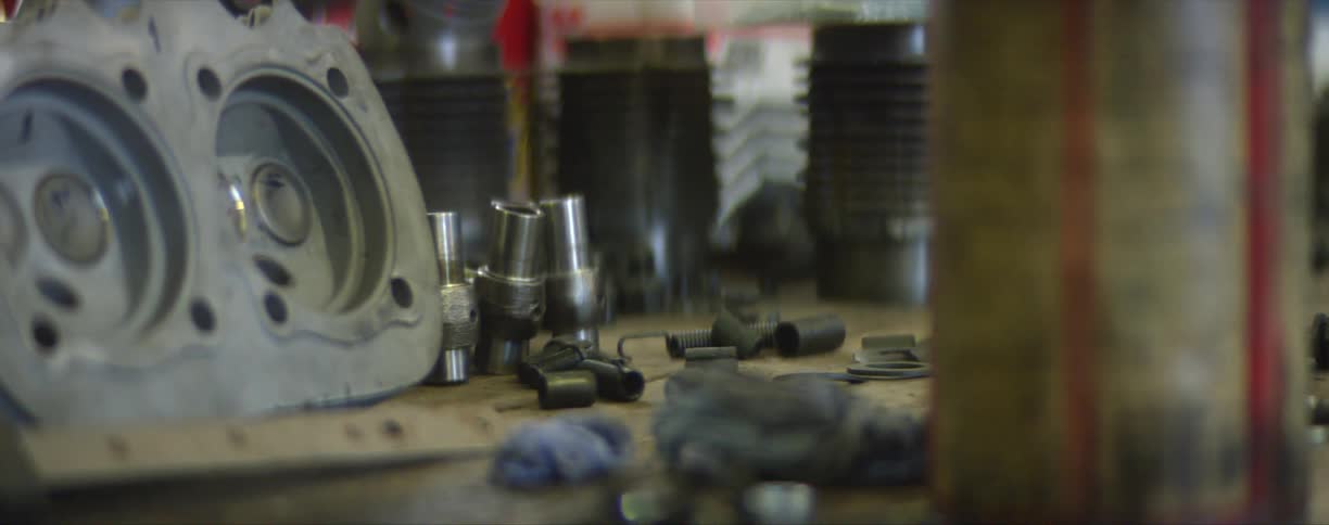 Automotive machinery parts and tools on a bench