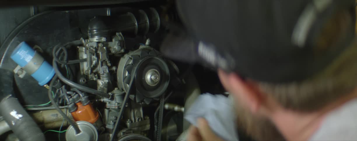 A mechanic checks the oil in a car
