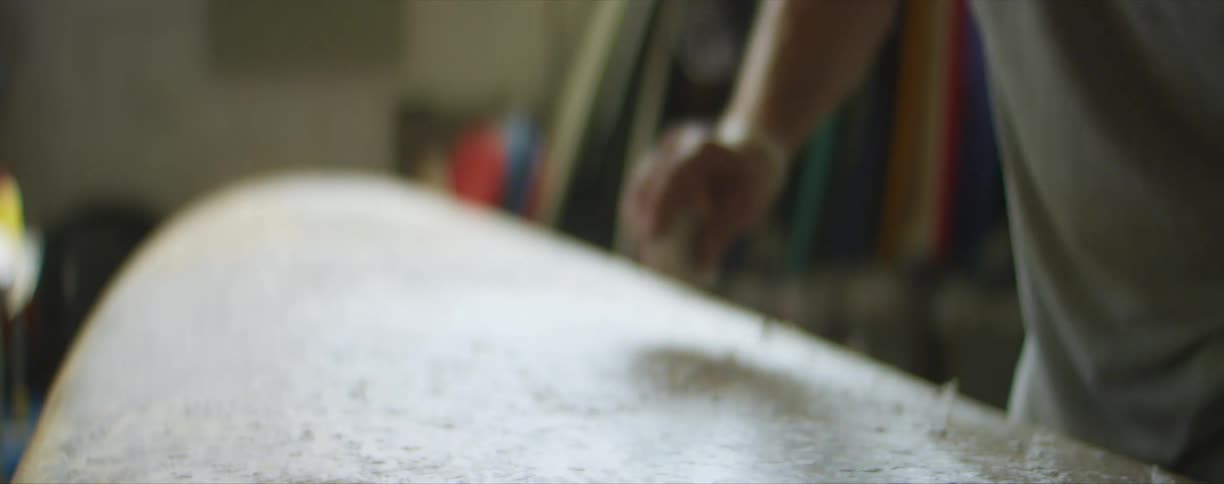 A person is sanding some material