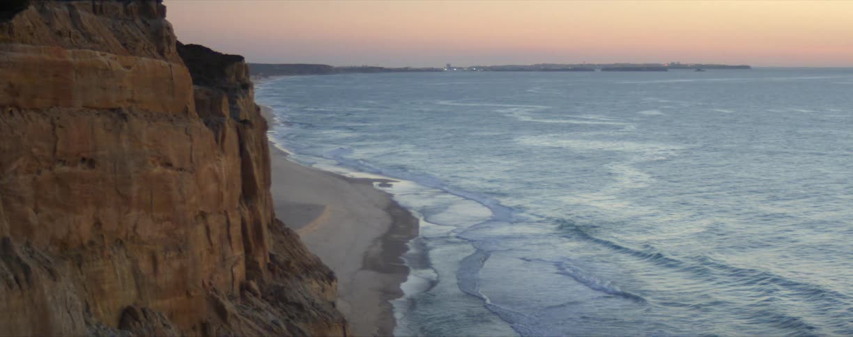 Coastal shoreline bluff with waves rolling in
