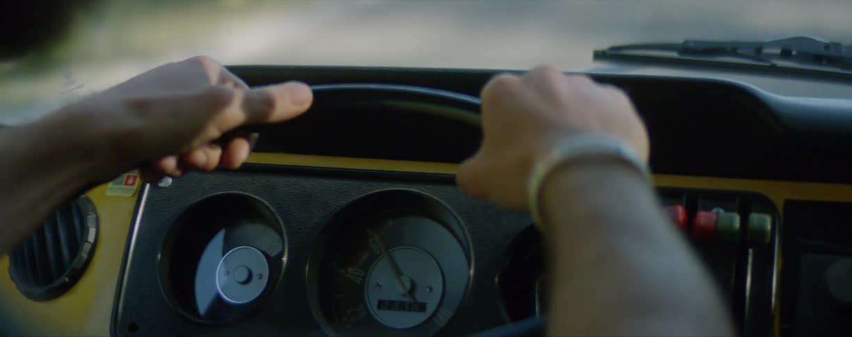 Mans hands hold classic car steering wheel