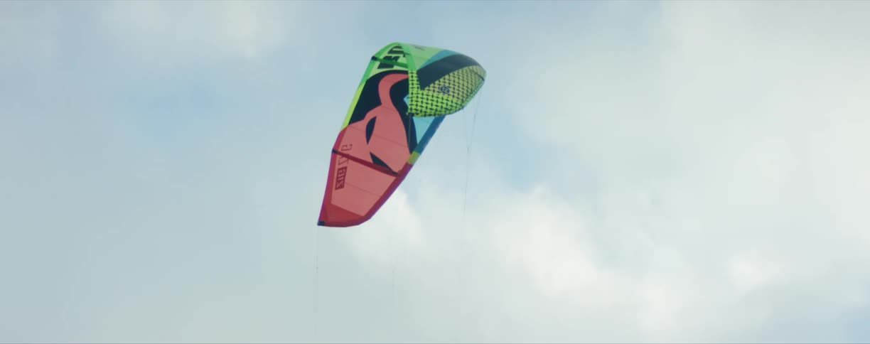 A kite flying in front of a cloudy sky