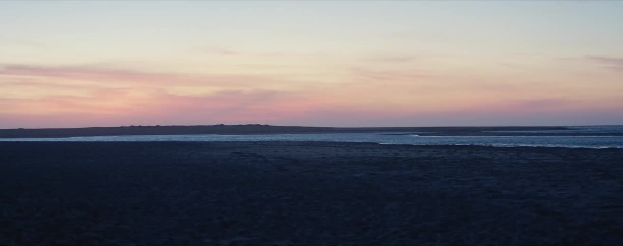 Wide shot of a beach at sunset