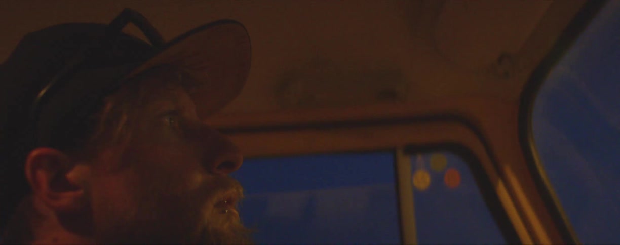 A man driving down a road