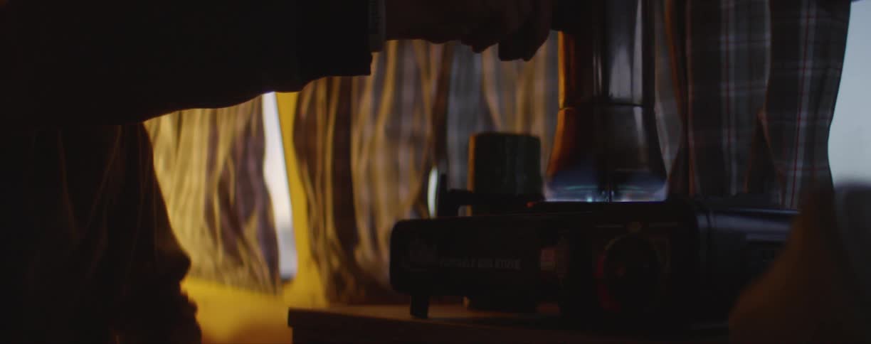 A person putting something on a stovetop