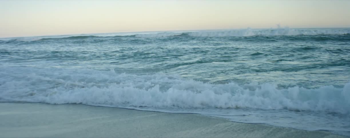 Waves splashing and rolling on over beach