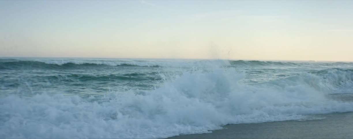 Tidal waves rolling in on the beach from the ocean