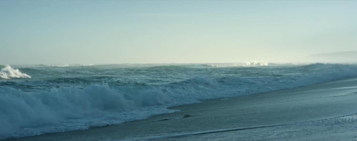 Ocean waves rolling in over beach