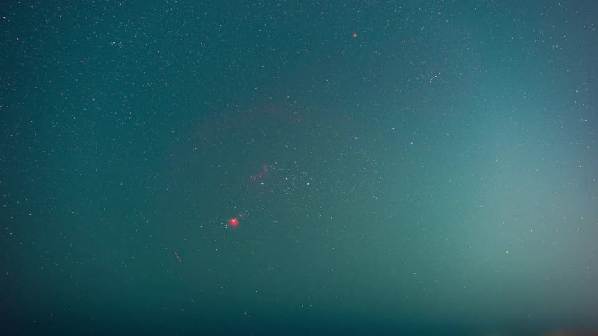 Time lapse of the night starry sky tracking the stars over the beach