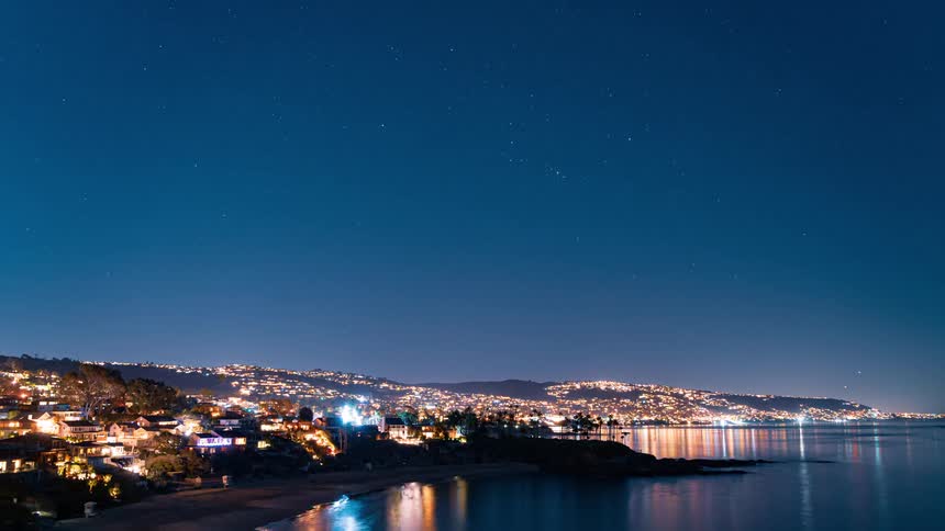 Vehicles travel over the coastline of a metropolis at night