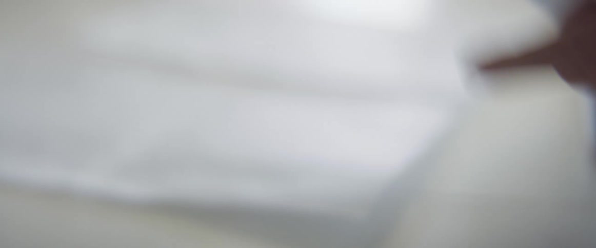 A person shuffling papers at her desk
