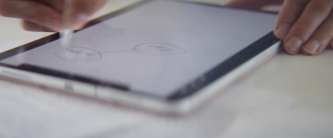 Woman writes and draws with a pencil stylus on a tablet