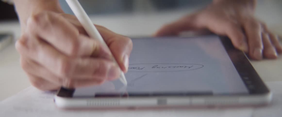 A person uses a stylus to draw a chart on a tablet