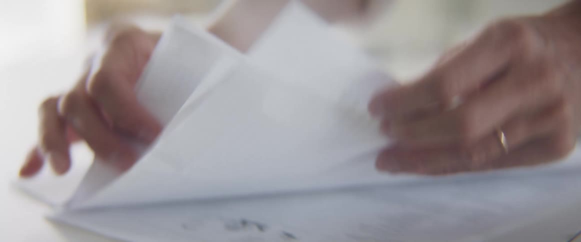 Womans hands sort documents on table