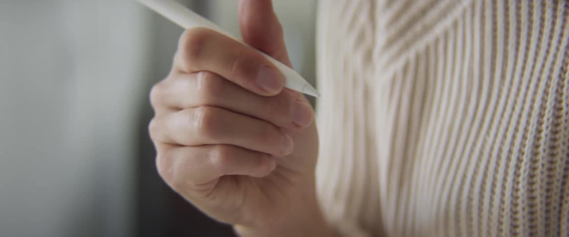 Woman considers then makes quick note