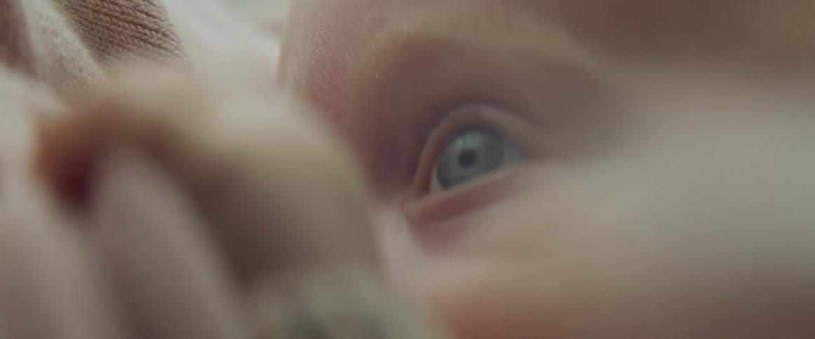 Close up of blonde and blue eyed baby breastfeeding