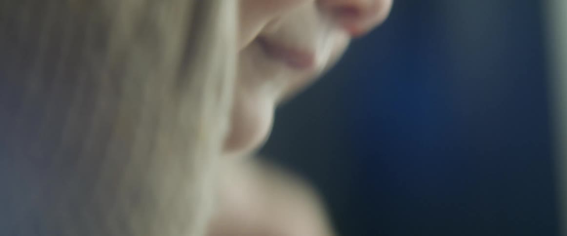 Close up of a babys face in a room at home