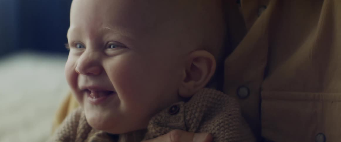 A mother holding her smiling child
