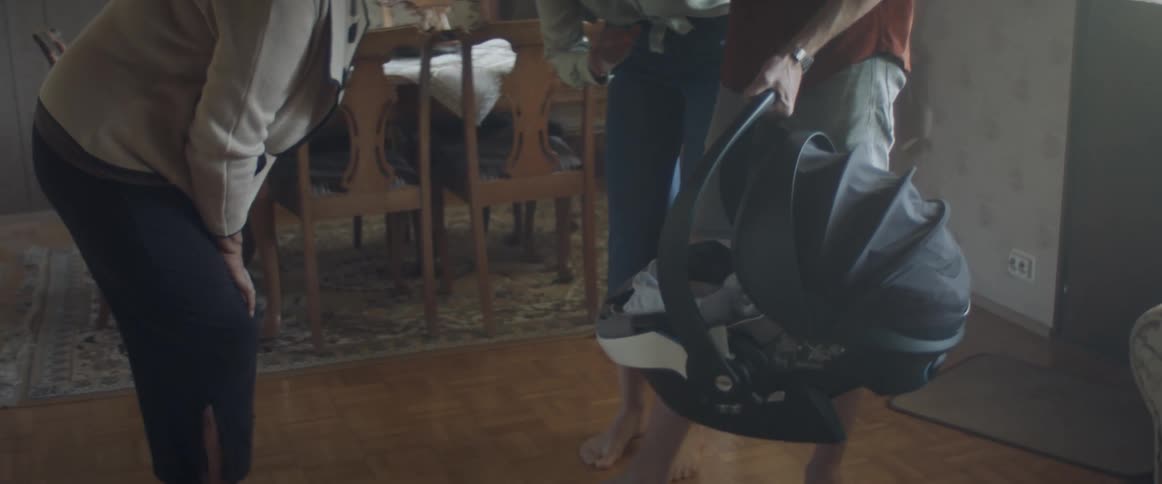Young couple bring the baby to grandmas house for a visit
