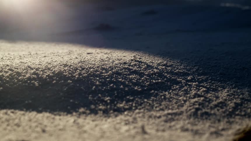 Light casts shadows across mound of particles
