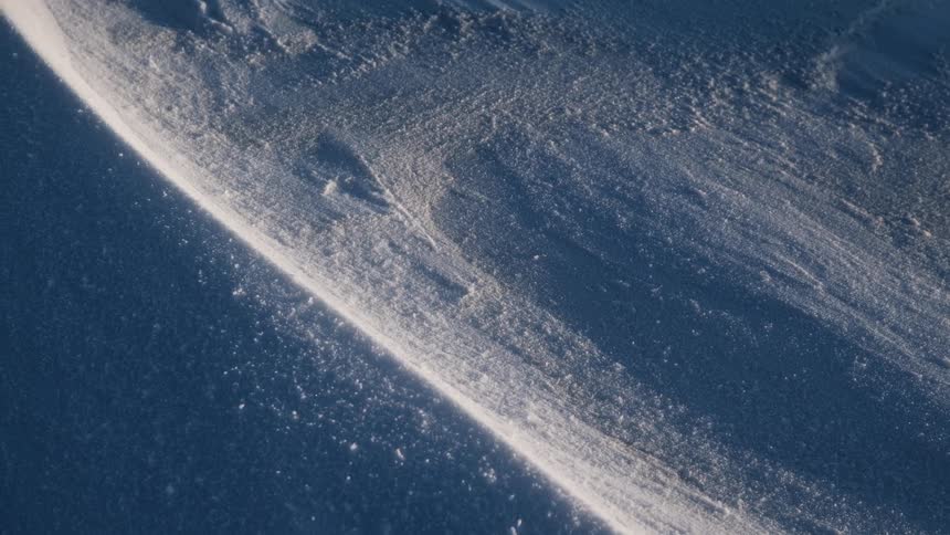 Shadows indicated low points in white powder against blue background
