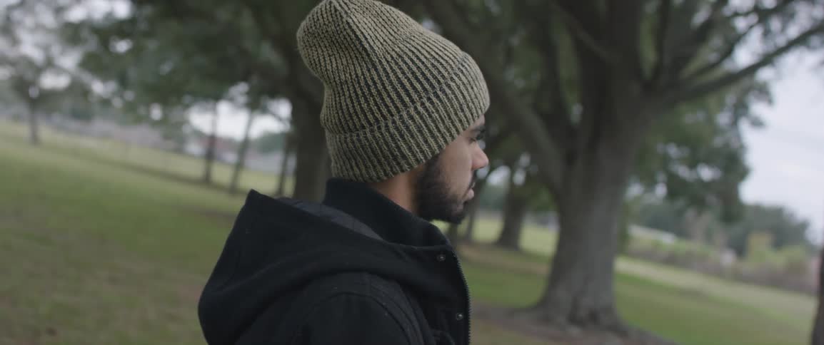 A man stands in a park during the day